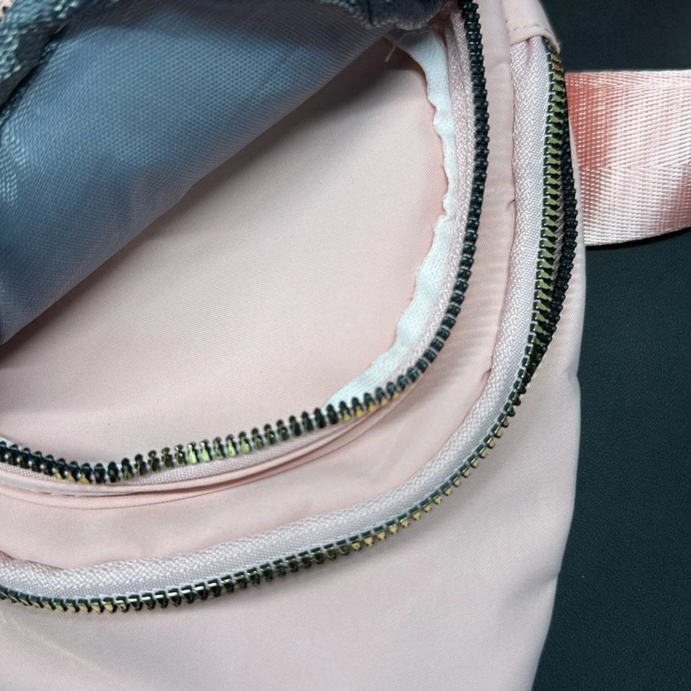 Pink Cross Body Backpack with gold zipper pockets